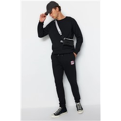 Черные мужские лицензированные спортивные штаны с резиновыми штанинами стандартного/нормального кроя с принтом Tom&Jerry TMNAW22EA0297